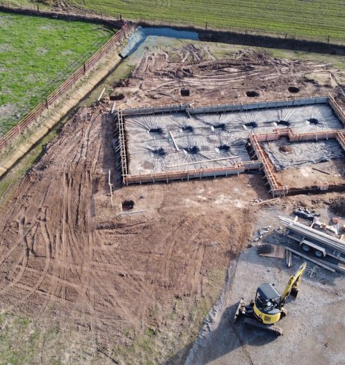 yellow and black heavy equipment on brown field during daytime